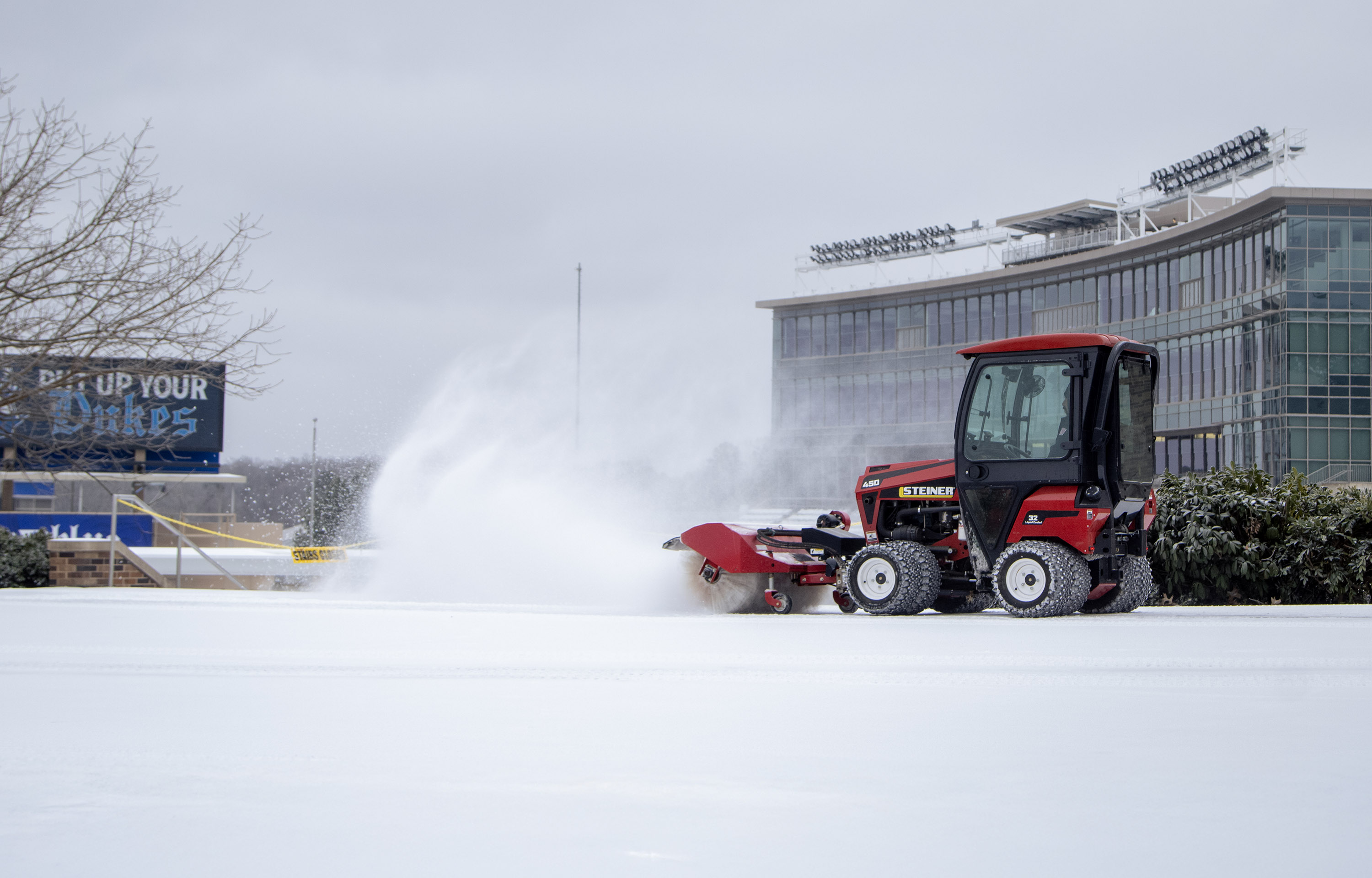 A plow going through ice and snow by Wallace Stadium