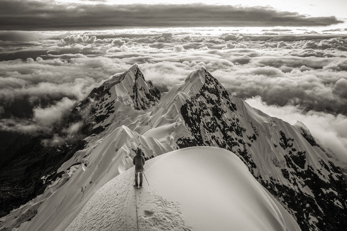 A person high in the Andes mountain taking photographs. 