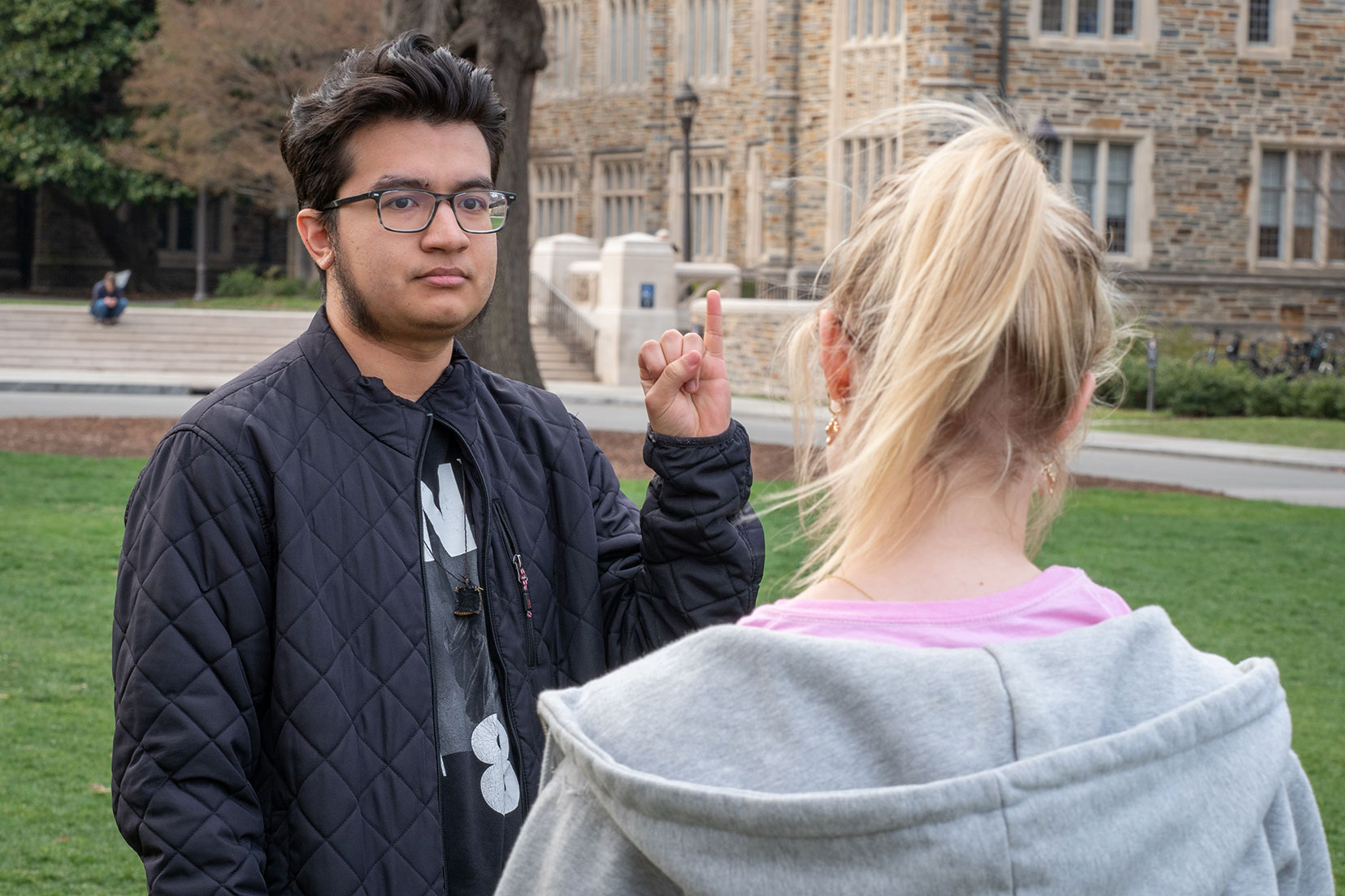 Two students practice sign language.
