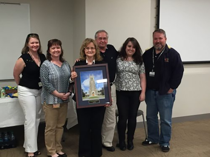 Louise Dillard, third from left, is surrounded by family members during her 2016 retirement celebration. Among fellow Duke employees pictured are daughter Emily Plummer, far left, daughter Phyllis Holt, second from left, granddaughter Haley Holt, second from right, and son Linwood Dillard, far right. Photo courtesy of Phyllis Holt.