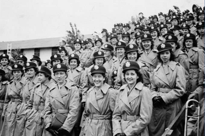 Nurses and servicemen of the 65th General Hospital awaiting embarkation for overseas. After fifteen months of training in military procedures at Fort Bragg, the unit left for England in 1943.