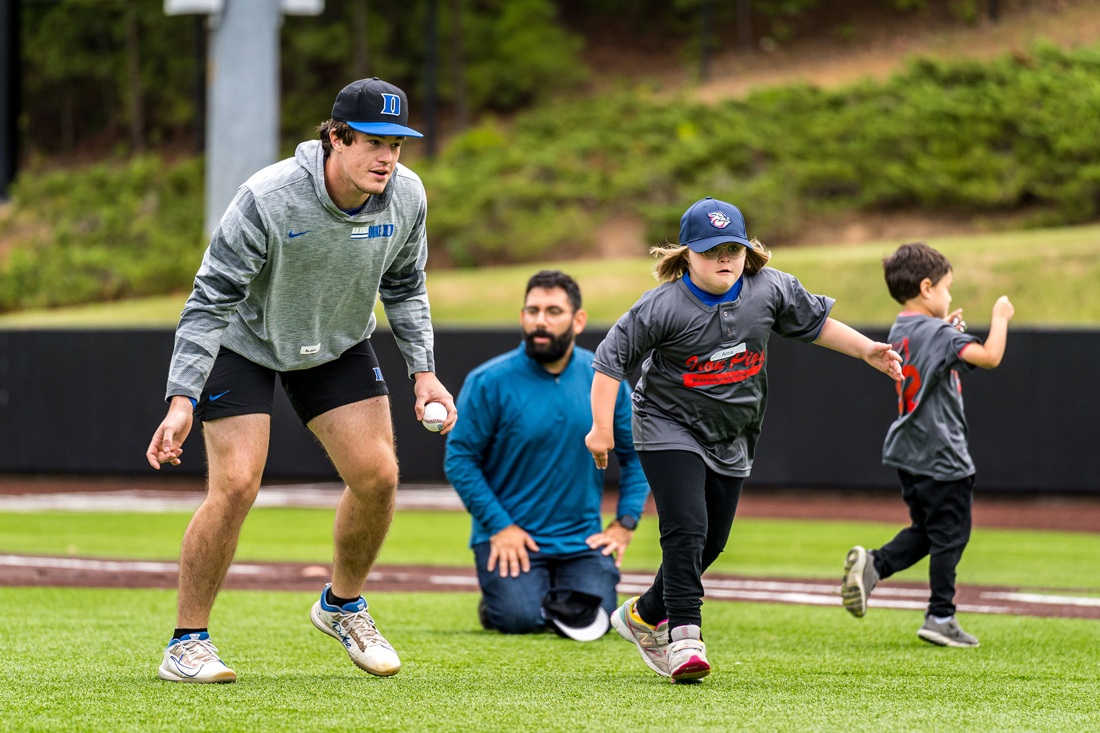 Young player gets lessons on infield work from Duke baseball players