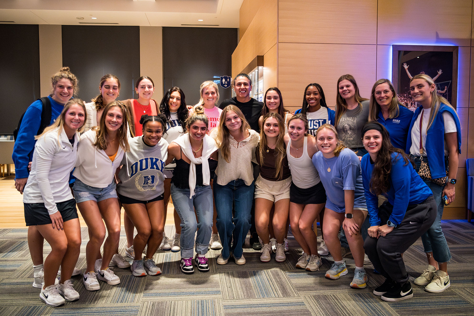Lyle Thompson (center back) with the women's lacrosse team at Duke
