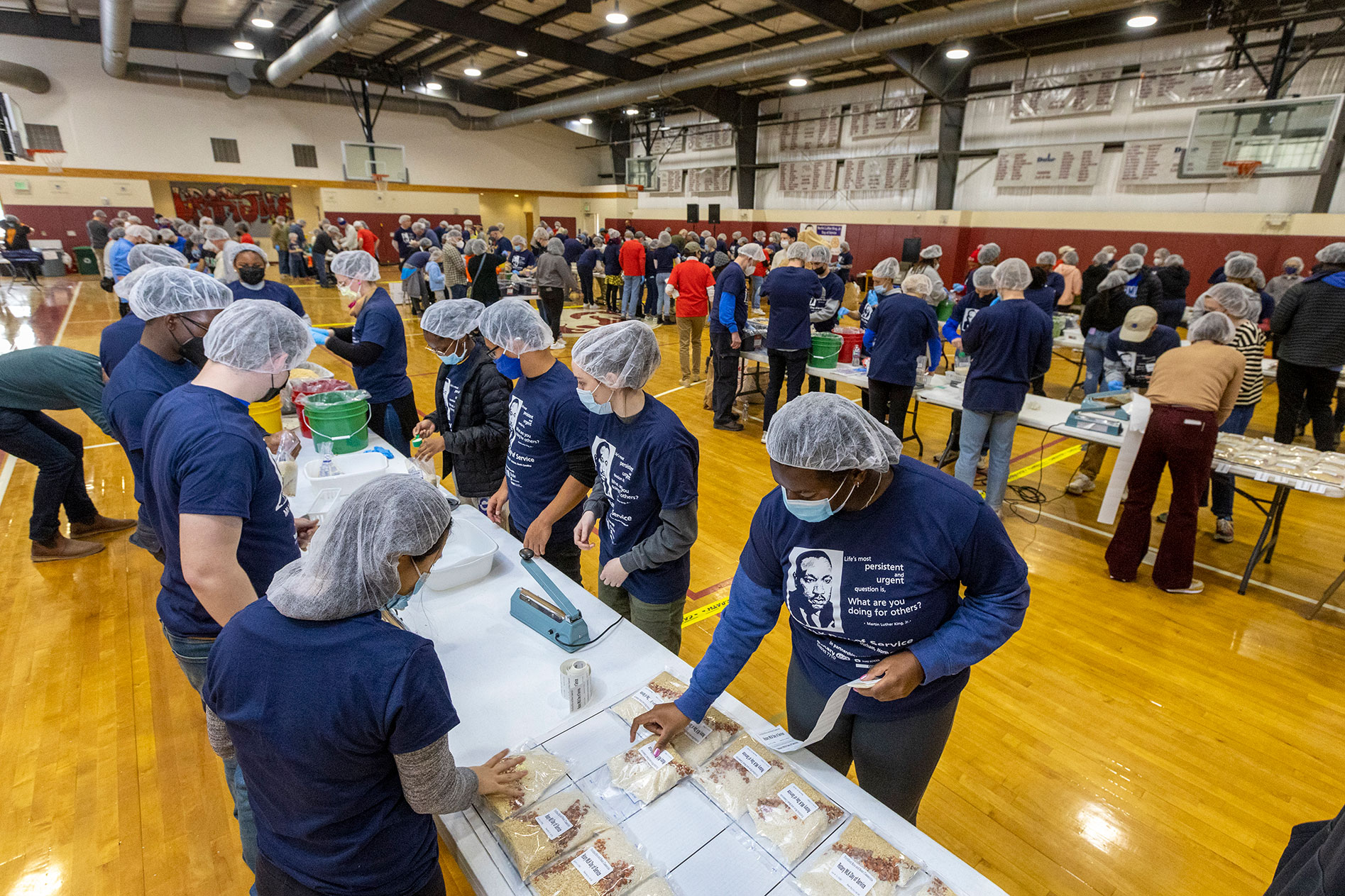 Duke President Vincent Price joined dozens of university students, faculty and staff, along with Triangle Rotary Club members in volunteering to support North Carolina food banks on Monday for a 2023 MLK Day of Service event supporting Interfaith Food Shuttle and Meals of Hope.
