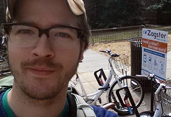 Graduate student Gabriel Yapuncich poses for a selfie by a rack of bikes with Duke's bike-share program, Zagster, as part of a social media activity for the Unpark Yourself Challenge. Photo courtesy of Gabriel Yapuncich.