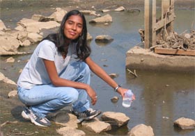 Pratt School of Engineering Graduate student Amrika Deonarine collects water samples for her study