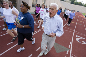 Al Buehler, right, leads Duke employees around the Wallace Wade track. 