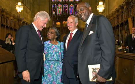 Former President Bill Clinton chats with the childhood friend of John Hope Franklin, Vivian Mildred Corbett Bailey, as Duke President Richard H. Brodhead and Vernon Jordan look on at the end of the celebratory ceremony Thursday in Duke Chapel. 