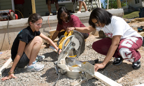 Duke student Chelsea Ursaner (left) works with NCCU students at a local Habitat for Humanity house in Durham. 