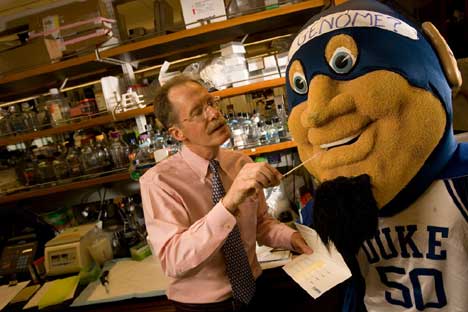 Jon Gardiner IGSP Director Huntington Willard takes a DNA swab from the Blue Devil mascot.