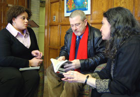 Azira Jones, a social work intern, left, and Bernie Stewart discuss reading with Polly Weiss of OIE. 