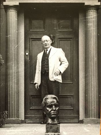 C.P. Curran standing behind the pedestal bust of WB Yeats