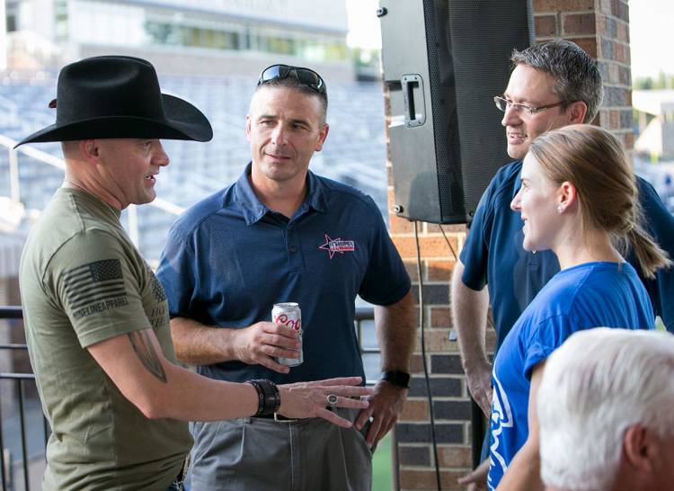 Performer Ryan Weaver and Lt. Col. Chris Hrudka, USMC, meet with Associate Dean of Student Affairs Clay Adams and Divinity School student Anna Page. Page is a graduate assistant in Duke’s Office of Student Veterans and a 2nd Lt. in the US Army Reserves.