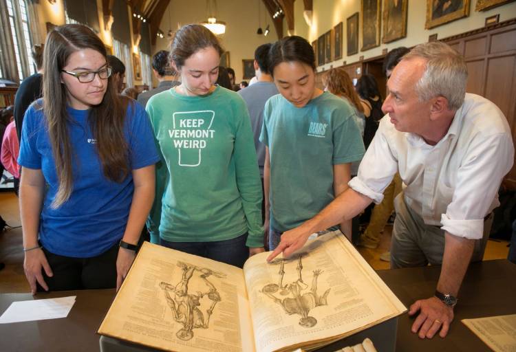 Andy Armacost, curator of collections, discusses an original Vesalius textbook of anatomical drawings from 1543 with first-year medical students Meg Bost-Aguilar, Sara Grundy, and Danae Olaso. Photo by Jared Lazarus, Duke University.