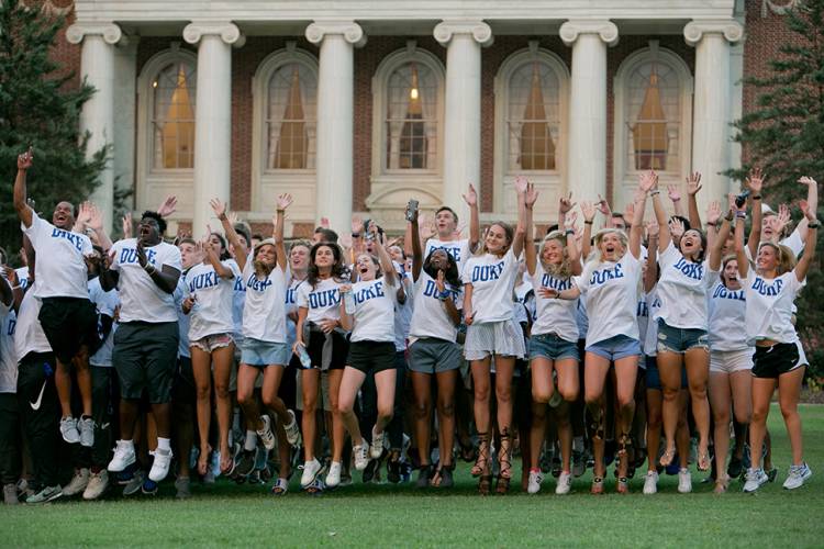 On cue from Coach Cutcliffe, the first-year students give a cheer. Photo by Jared Lazarus/Duke Photography