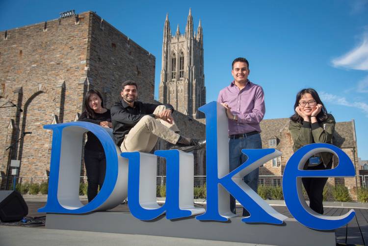 Students pose with the Duke Word Mark on the Plaza Thursday.