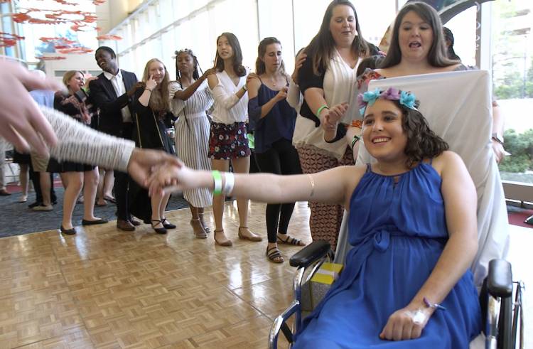 Isabel, a hospital patient, connects the conga line during the prom.