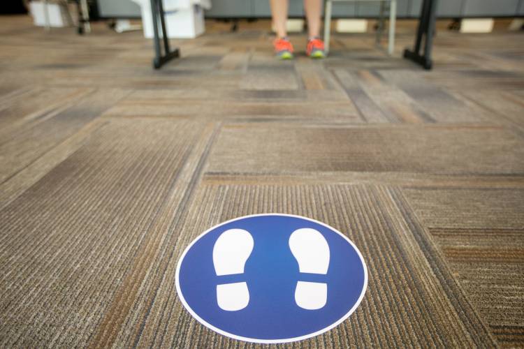 Signs telling students where to stand when waiting to be tested for COVID-19 in Penn Pavilion.