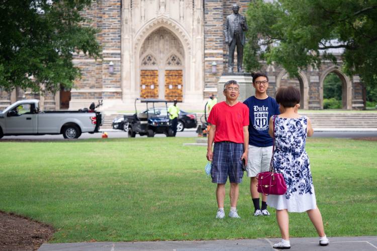 Incoming freshman and their families take selfies on Chapel quad on the first day of move-in for the class of 2024.