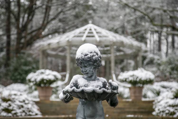 The statue in front of the gazebo in Duke Gardens on a snowy morning.