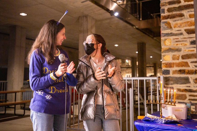 Student light the fourth candle of Hanukkah Photo by Jacob Whatley