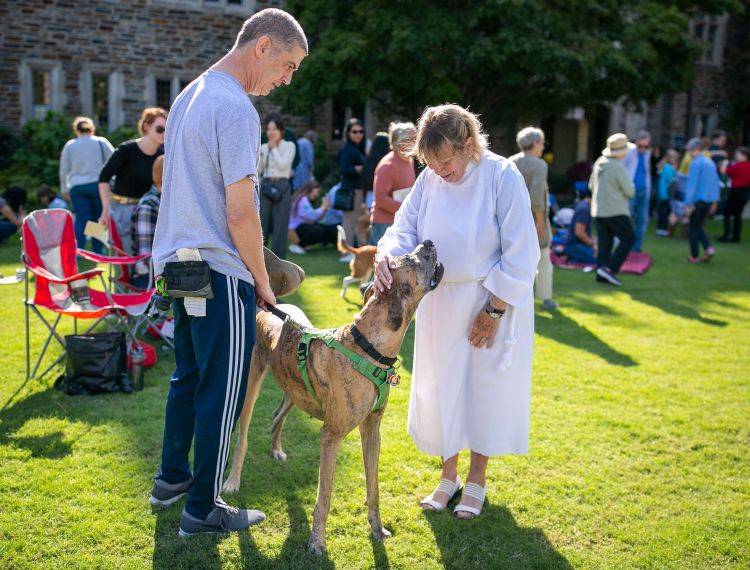 Rev. Rondy Elliott, founder of the Blessing of the Animals at Duke Chapel, blesses a Great Dane.