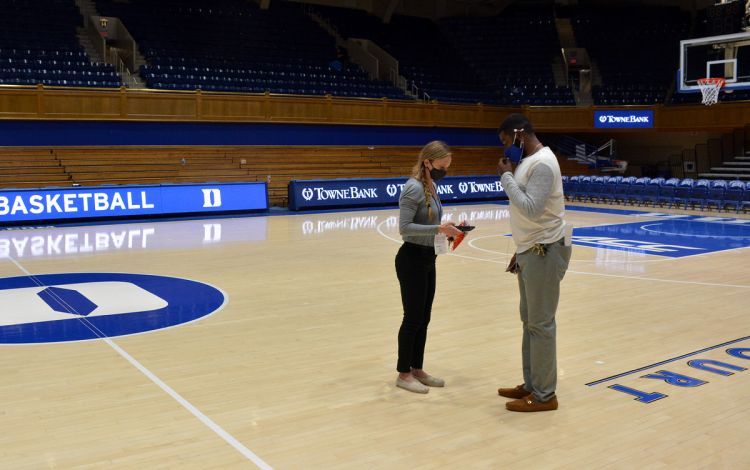 Alli Slater and Jamal White go over details following the game. Photo by Stephen Schramm.