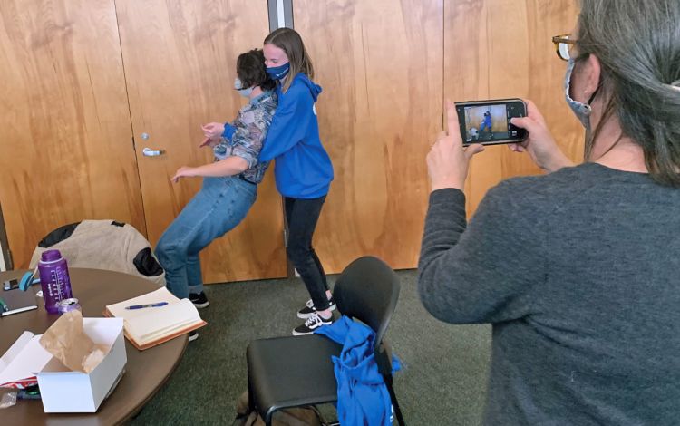 Kathy Sikes, right, takes a photo of an AmeriCorps trust fall training session during the pandemic. Photo courtesy of Kathy Sikes.