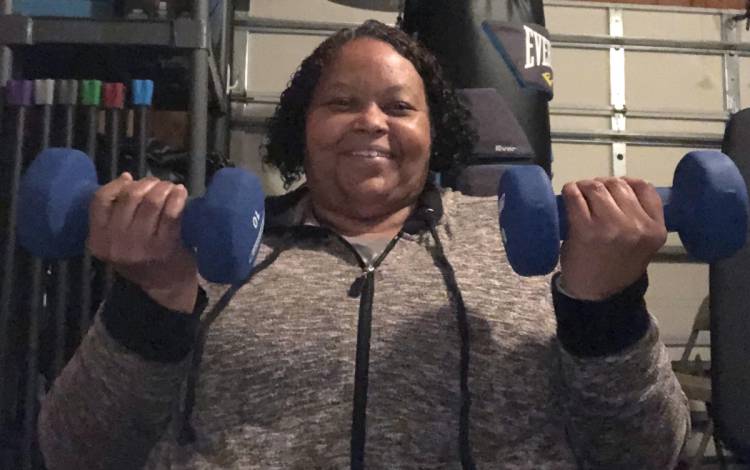 Barbara Stokes lifts 10-pound weights in her garage. Photo courtesy of Barbara Stokes.