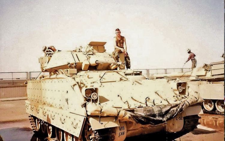 Barry Grauel, a U.S. Army veteran who served in the 82nd Airborne Division, stands atop a tank in Kuwait in 1991. Photo courtesy of Barry Grauel