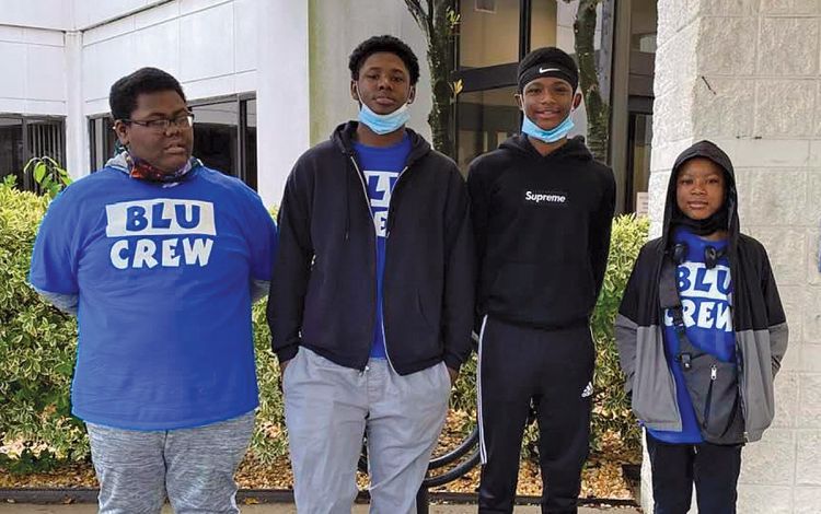 Ruby Thompkins helps guide the Blu Crew, a volunteer group started by her grandson, Messiah, left. Photo courtesy of Ruby Thompkins.