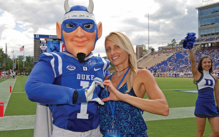 If you see the Duke Blue Devil mascot at a sporting event, odds are Duke cheerleading coach Alayne Rusnak, above, is nearby.