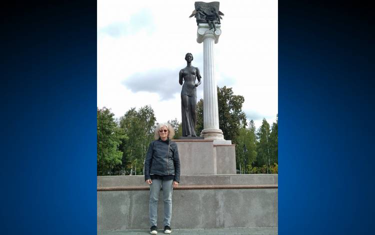 Carol Apollonio poses in front of a statue in Tomsk, Russia. Photo courtesy of Carol Apollonio.