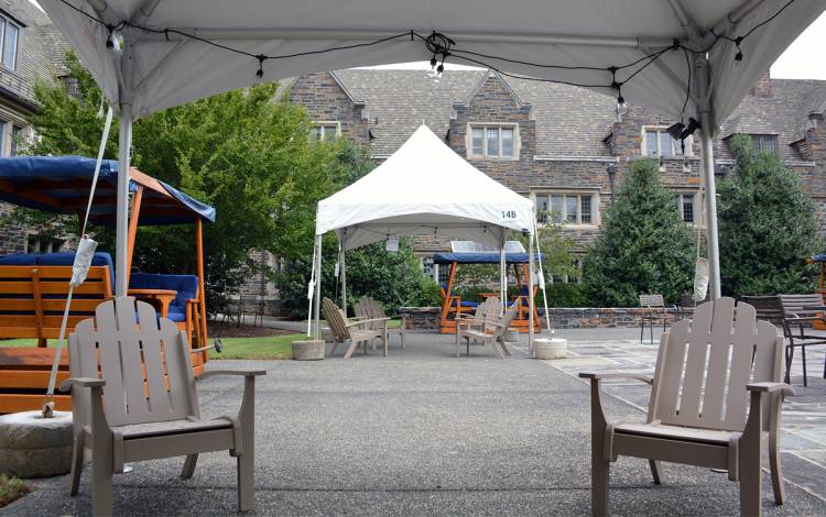 Duke staff placed Adirondack chairs underneath tents in Keohane Quad. Photo by Jonathan Black.