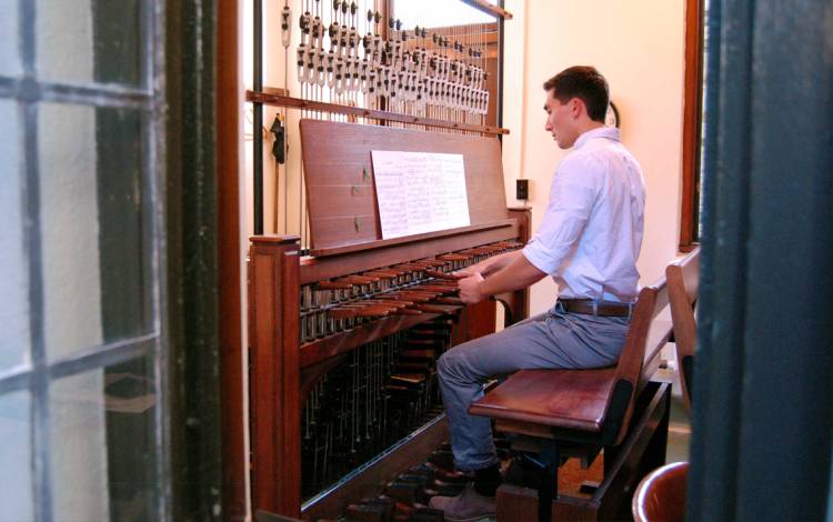 From a small room nestled high in the Duke University Chapel tower, Joey Fala plays the carillon. Photo by Stephen Schramm.