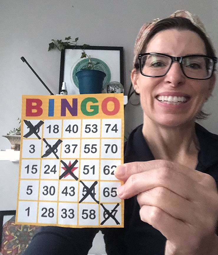 Chris Clark holds up one of the BINGO cards used in the Friday game she organizes with DCRI colleagues. Photo courtesy of Chris Clark.