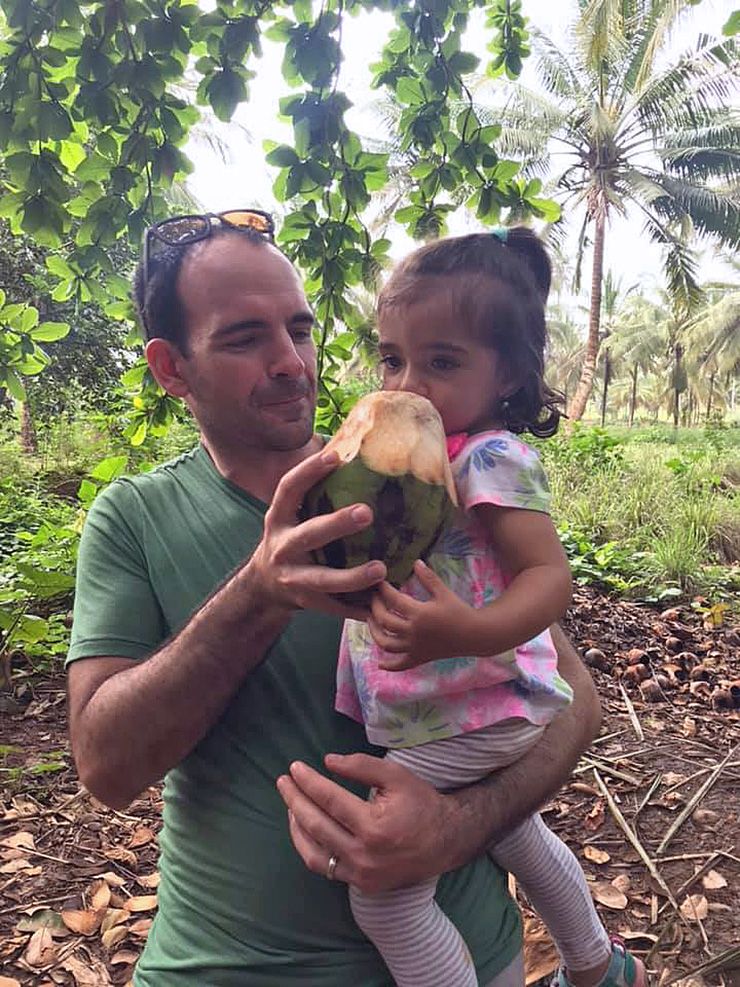 Brandon Knettel shares a coconut with his daughter, Josie. Photo courtesy of Brandon Knettel.