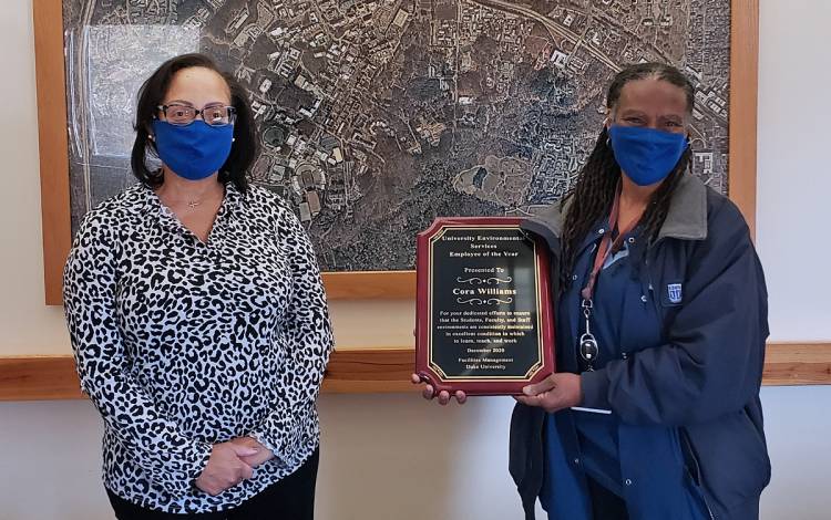 Housekeeping Specialist Cora Williams, right, holds her Employee of the Year award alongside Duke University Environmental Services Director Leslye Kornegay. Photo courtesy of Duke Facilities Management.