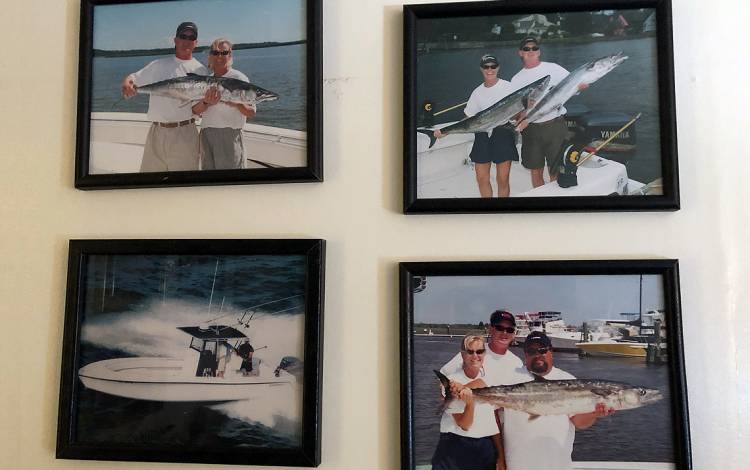 Fishing tournament photos of Dot Mishoe hang in her campus office. Photo by Leanora Minai.
