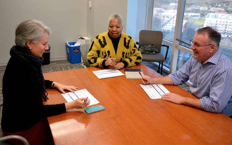 (Left to right) Culver Scales, Valerie Riddick and Jeff Chitester discuss onboarding for a new hire. Photo by Jonathan Black.