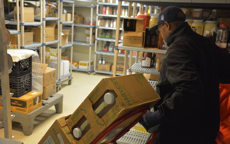 Duke Dining's Leonard Bass brings items into the kitchen at East Campus Marketplace. Photo by Jonathan Black.