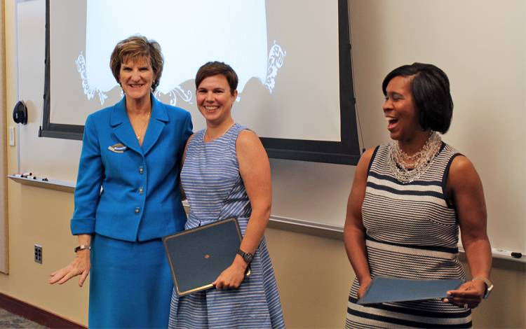 Libby Joyce, center, is greeted by Marion Broome, Dean of the School of Nursing, left, and Duke Learning and Organization Development Director Keisha Williams, right.