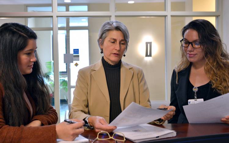 Diane Uzarski, center, meets with colleagues at the Duke University School of Nursing. Photo by Jonathan Black.