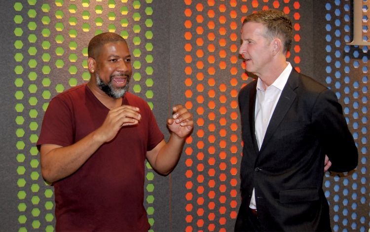 After the ceremony, artist and project leader J. Brandon Johnson, left, spoke with Executive Vice President Daniel Ennis about the communal work. Photo by Jack Frederick.