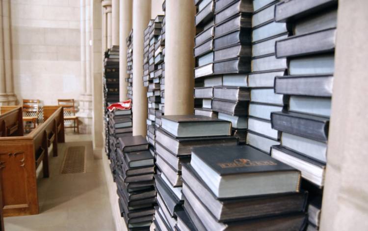 Bibles and hymnals, normal spread long the pews, are stacked in corners of Duke Chapel. Photo by Stephen Schramm.