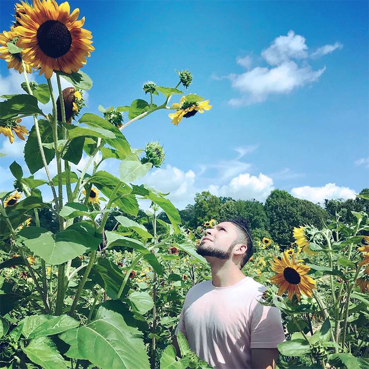 Elmer Orellana explores a sunflower field in Raleigh's Dorothea Dix Park. Photo courtesy of Elmer Orellana.