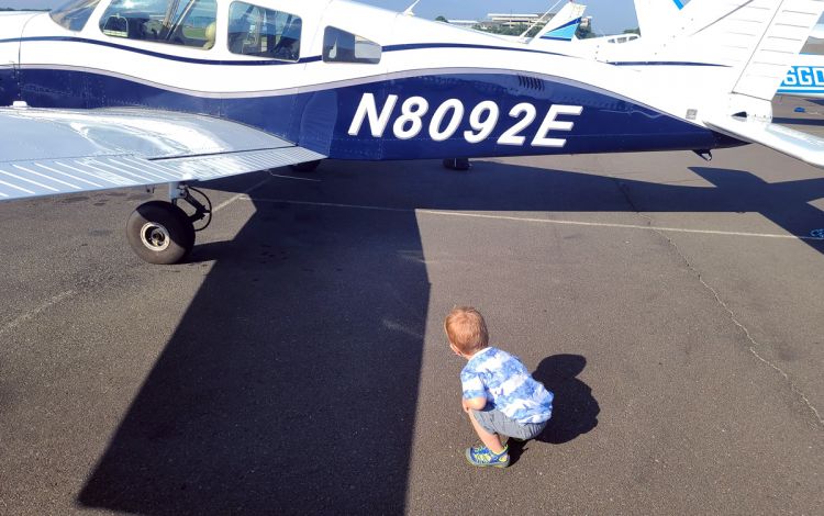 A child looking at an airplane.