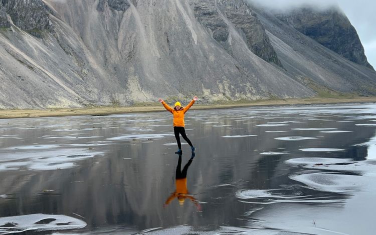 A woman in front of a mountain