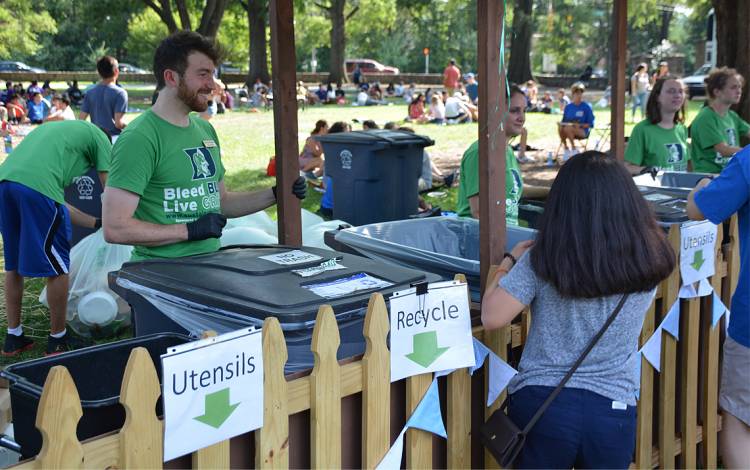 Tani Colbert-Sangree assists guests in composting and recycling their leftovers, utensils and plates at the Zero Waste Picnic.