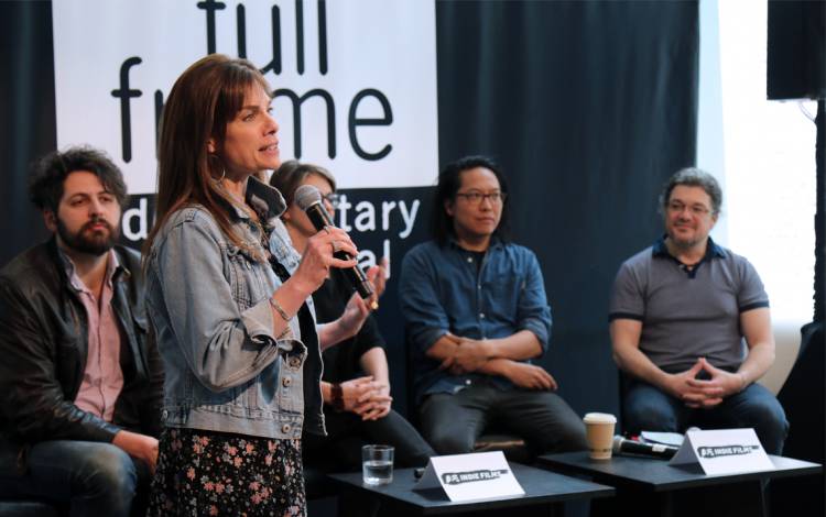 Deirdre Haj, left, speaks at the Full Frame's Speakeasy venue, where debates and discussions between professionals working in the field occur in front of an audience. Photo courtesy of Full Frame.